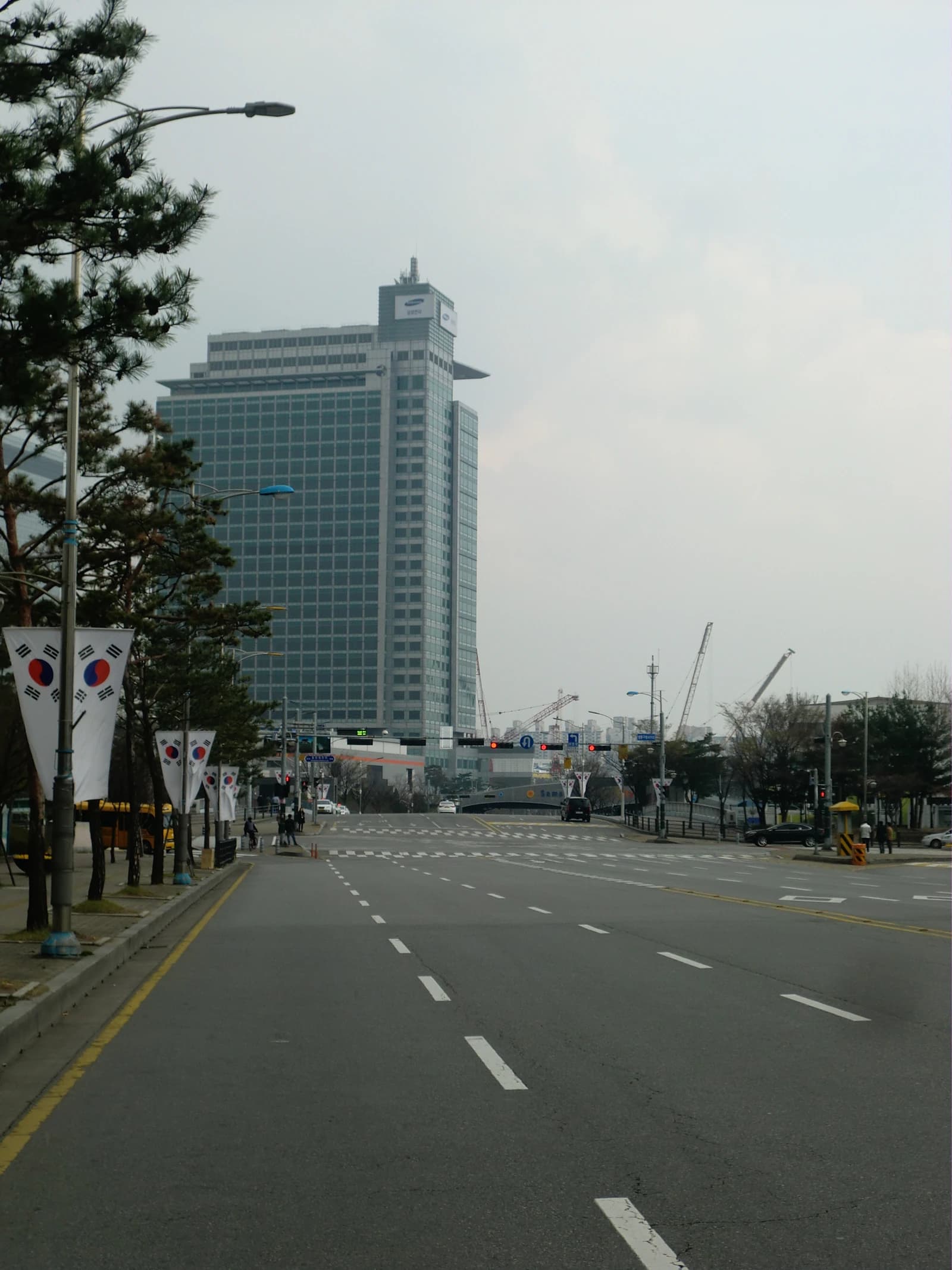 Samsung Electronics building, a large corporate tower, stands above a city street.