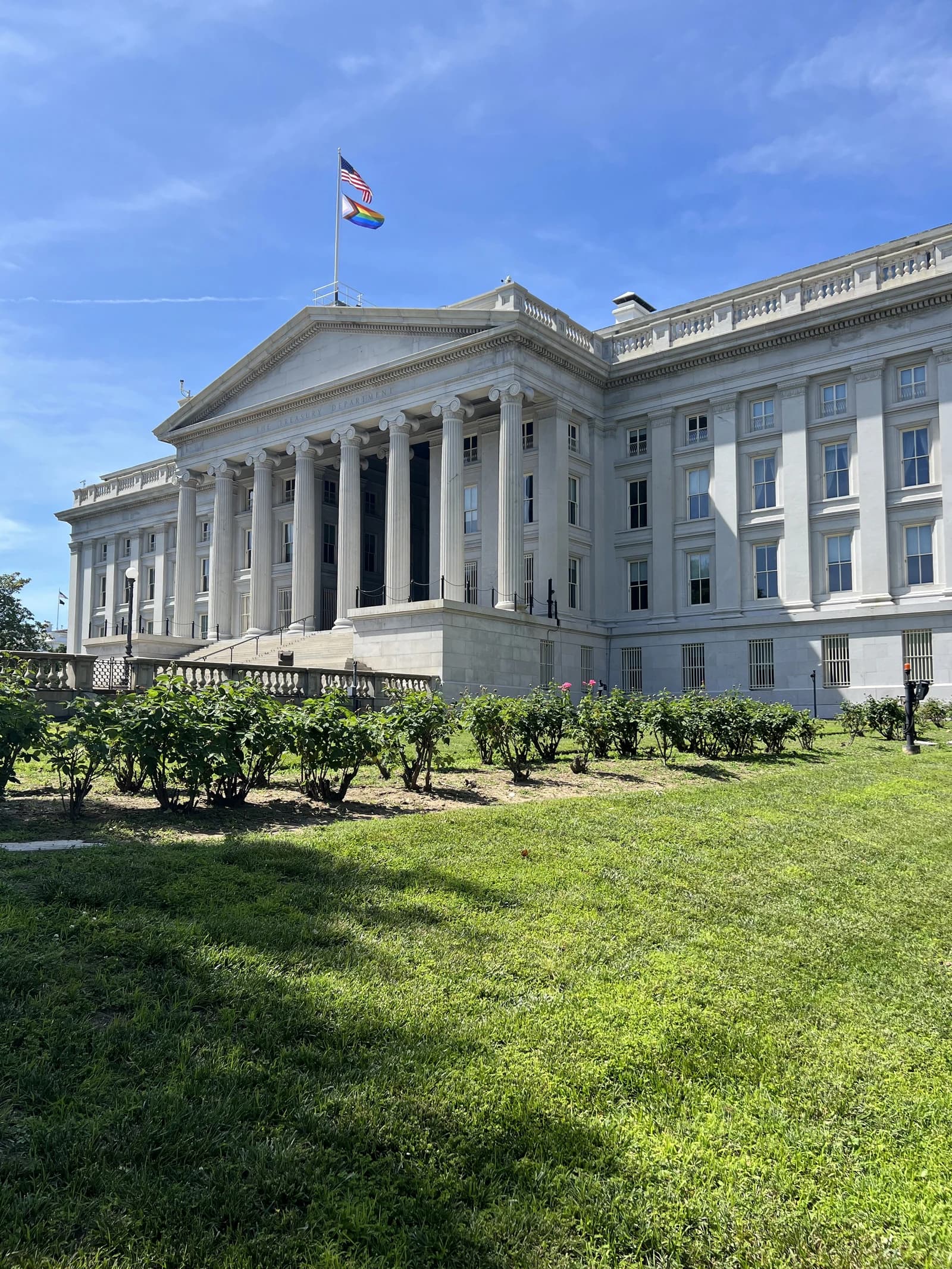 The United States Treasury Department Building facade on a sunny day.