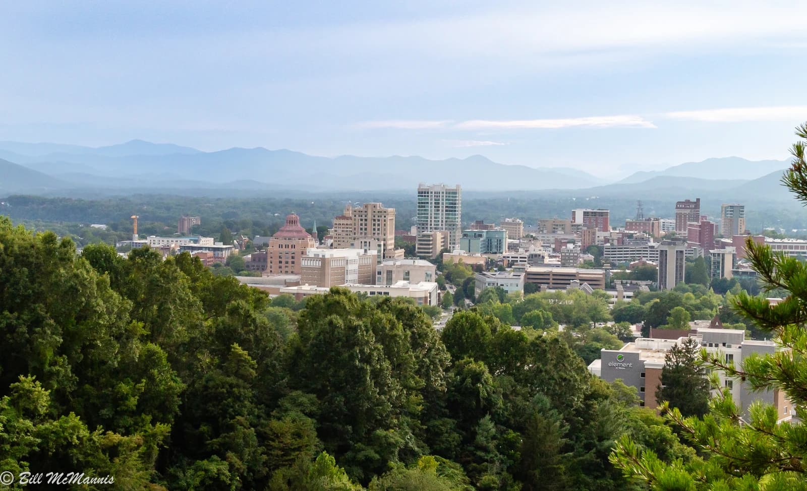 Asheville, North Carolina skyline viewed from Beaucatcher Mountain with distant mountains.