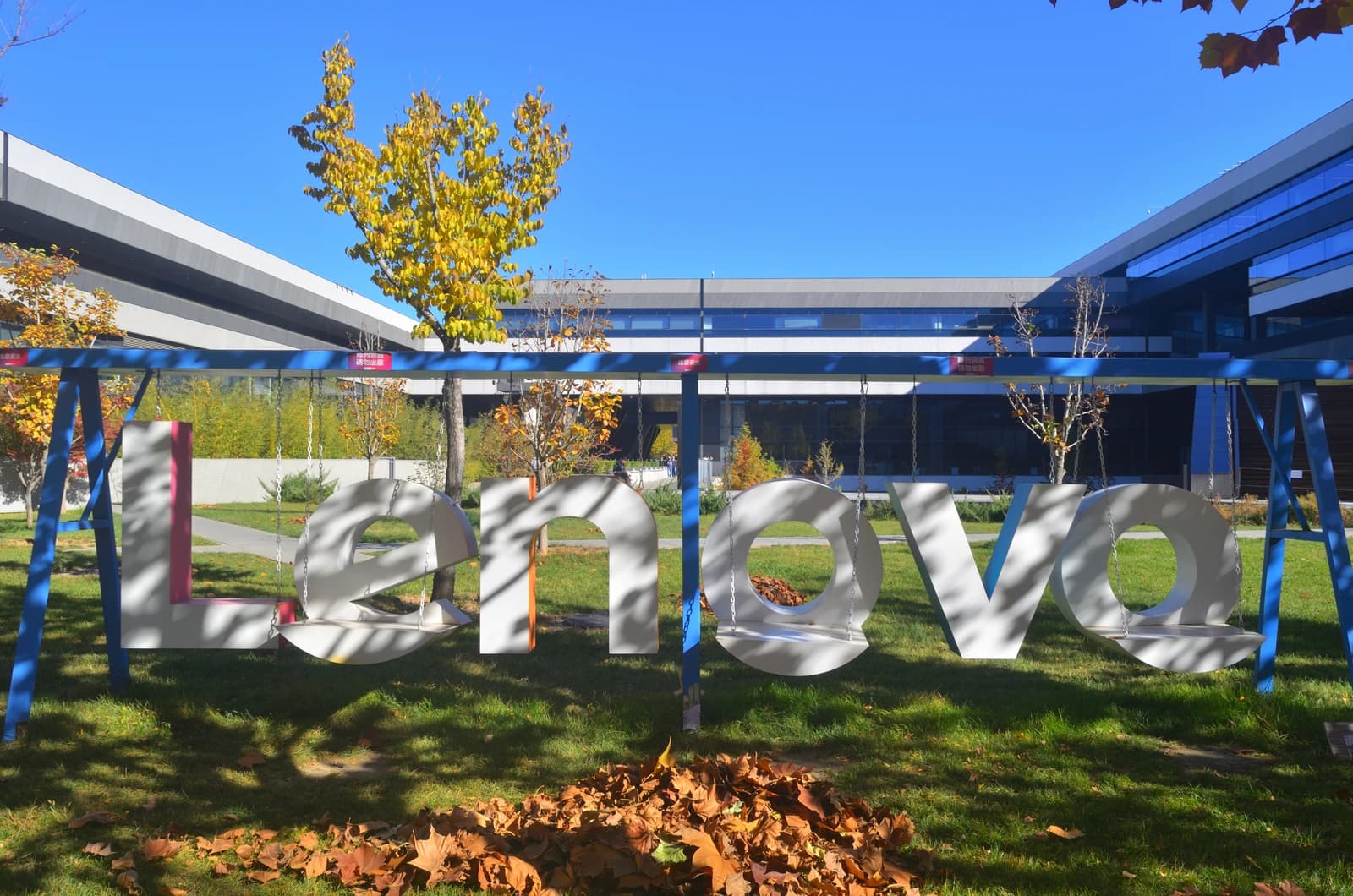 Lenovo headquarters building exterior with large corporate branding sign on a sunny day.