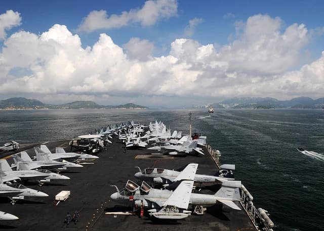 US Navy aircraft carrier USS Ronald Reagan with planes on deck transiting towards Hong Kong.