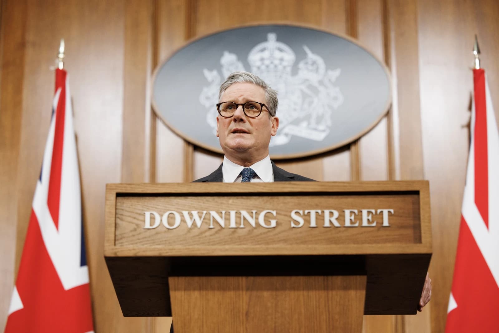 Keir Starmer, UK Prime Minister, speaking at a podium with the Downing Street sign.