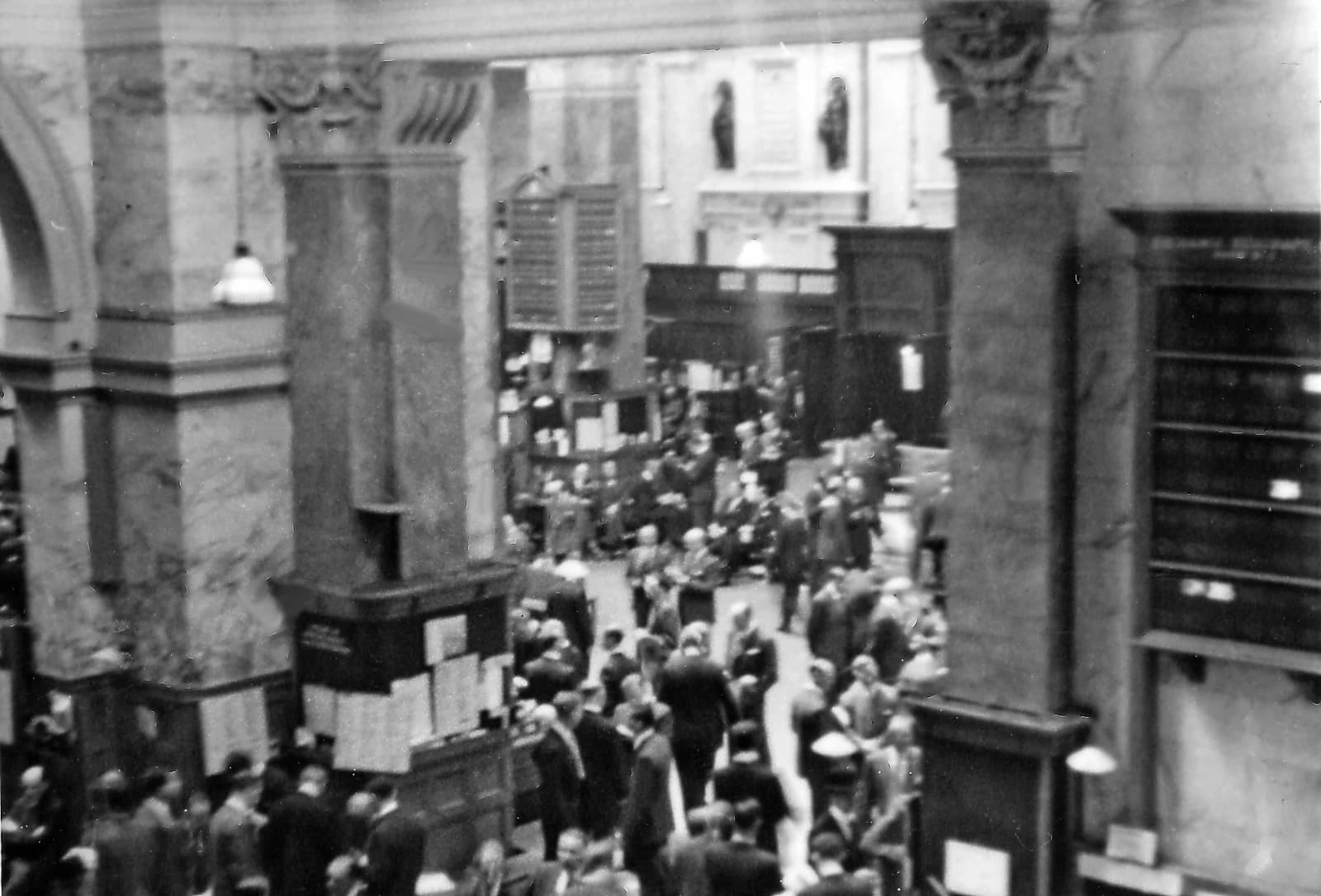 Traders standing on the floor of the London Stock Exchange.