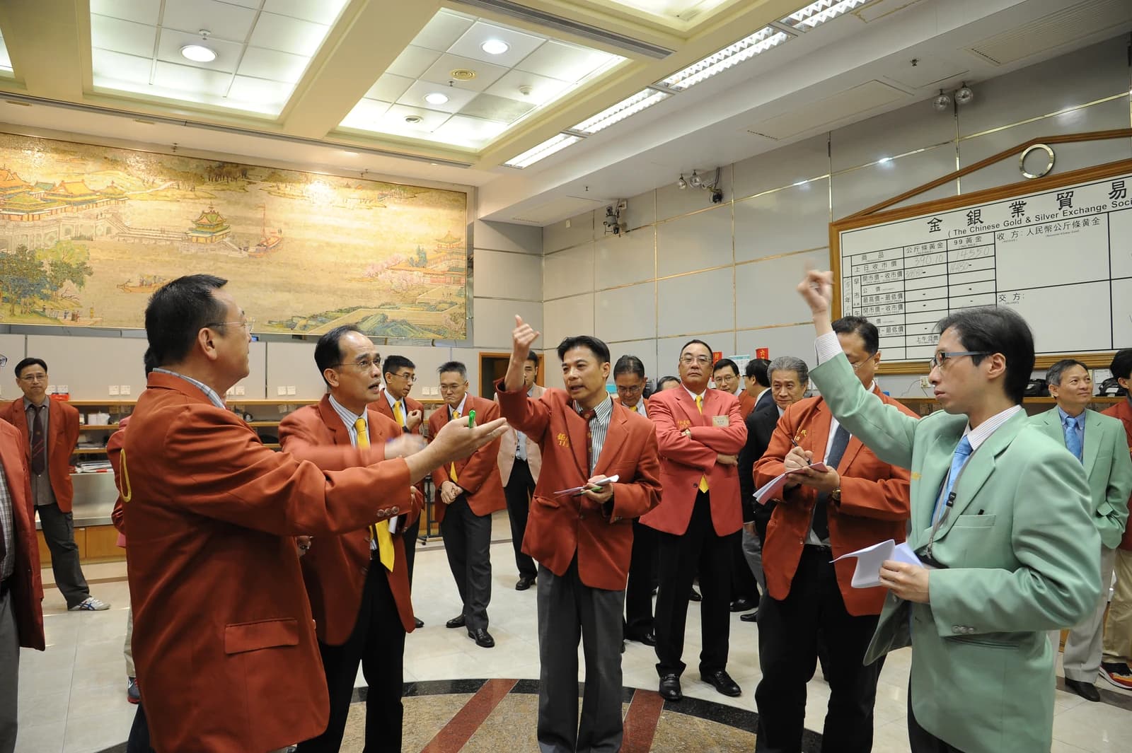 Traders at the Chinese Gold and Silver Exchange Society making hand signals to each other.