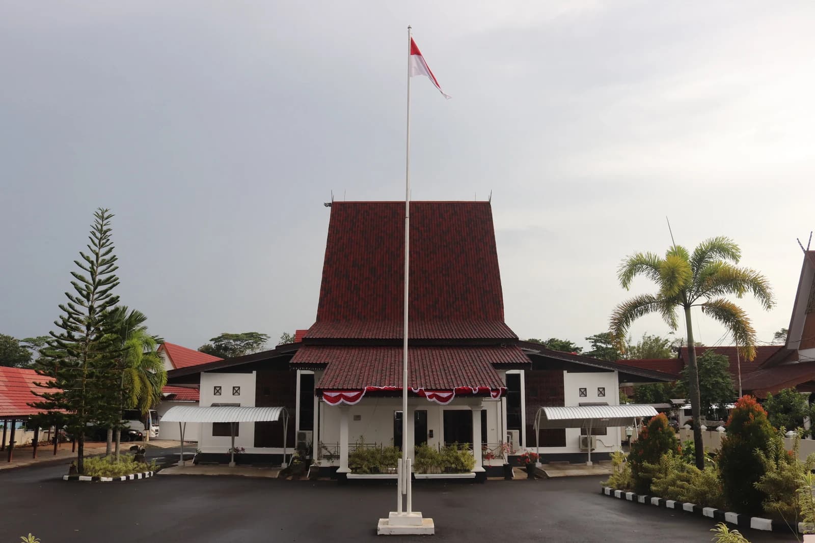 Exterior view of the DPRD building in Tanah Laut, with the Indonesian flag flying.