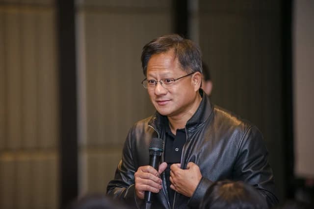 Jensen Huang, CEO of Nvidia, speaking into a microphone at an event.