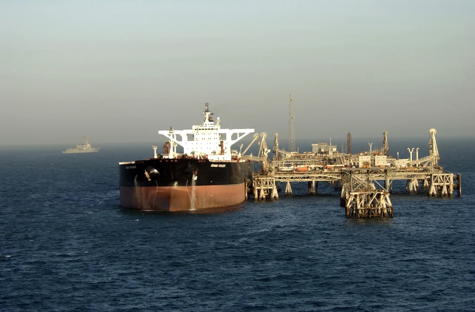 Guided missile destroyer USS Preble patrols waters near the Al Basrah Oil Terminal as a supertanker takes on crude oil.