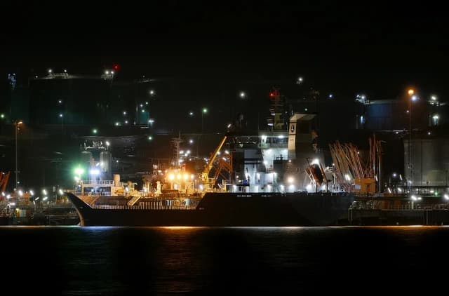 Product terminal at Preemraff Lysekil with tankers docked at night.