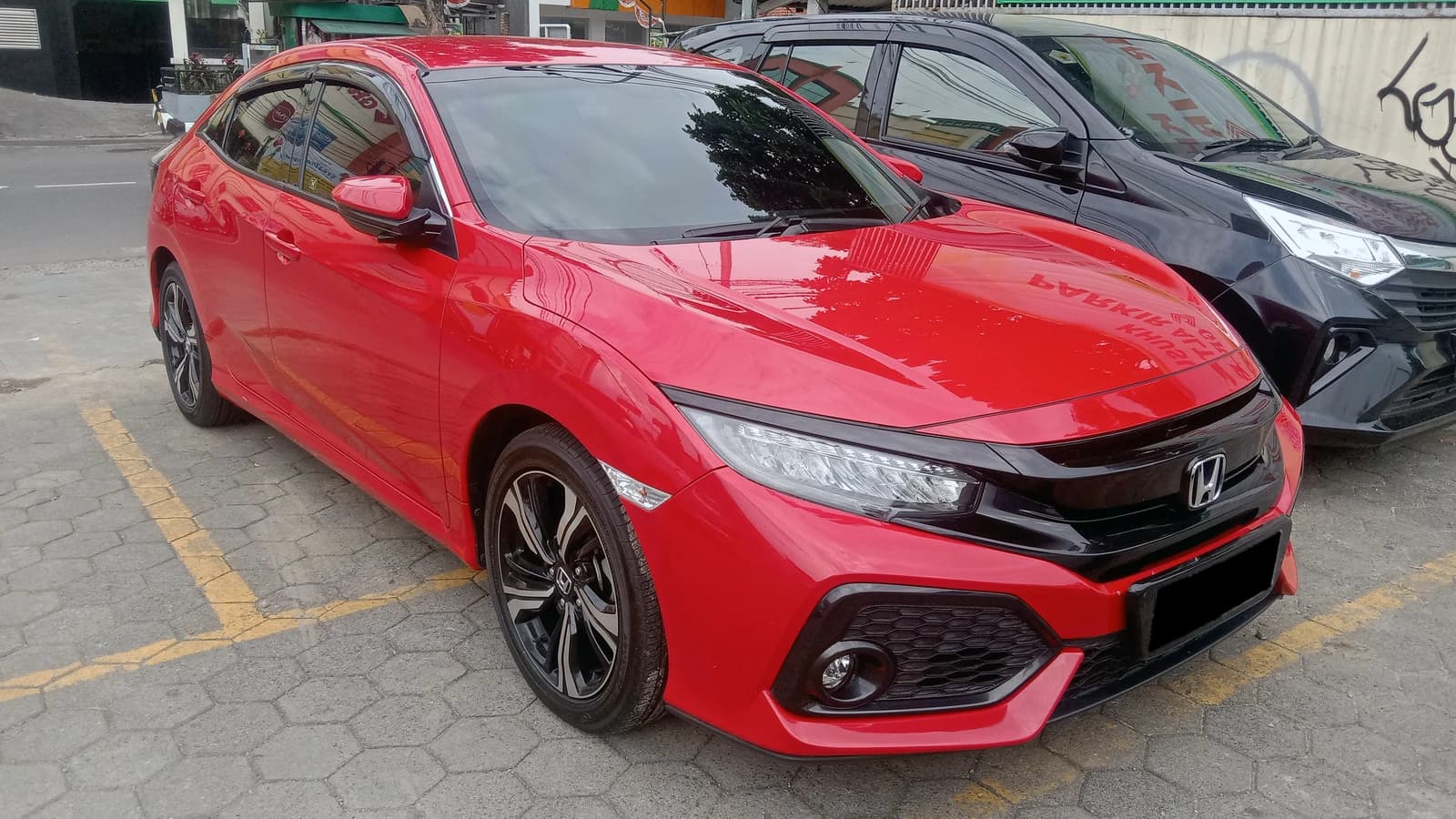 Red 2019 Honda Civic Hatchback 1.5 VTEC Turbo E parked on a street.