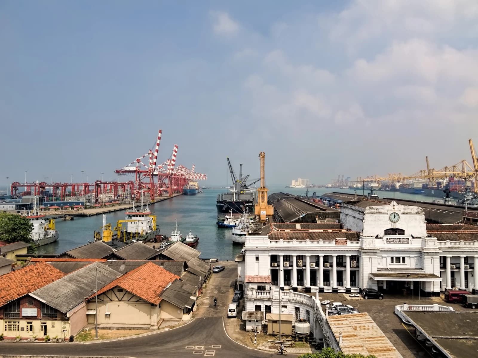 Aerial view of Port of Colombo, Sri Lanka, showing ships, cranes, and waterfront buildings.