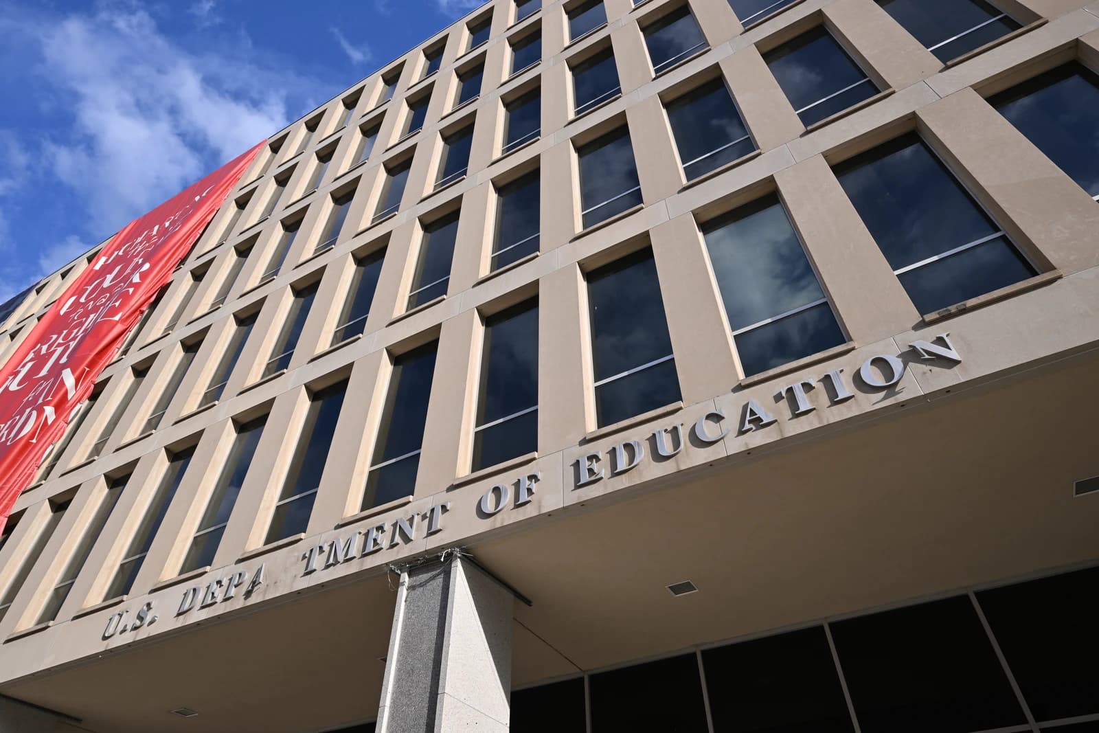 Exterior of the U.S. Department of Education building with missing letters.