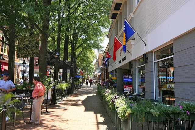 Pedestrians and outdoor diners on the Downtown Mall in Charlottesville, Virginia on a sunny day.