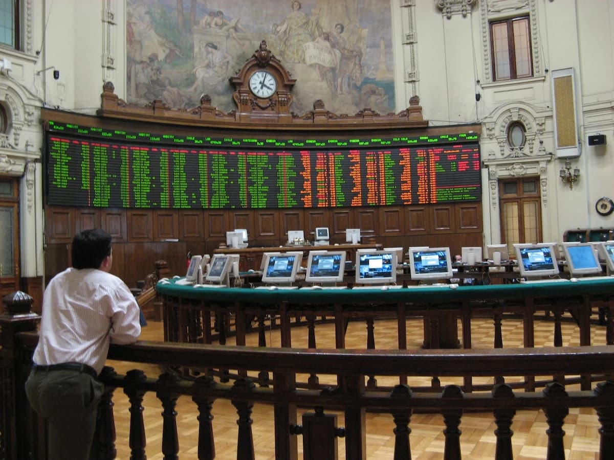Interior of the Santiago Stock Exchange building with a large stock ticker board.