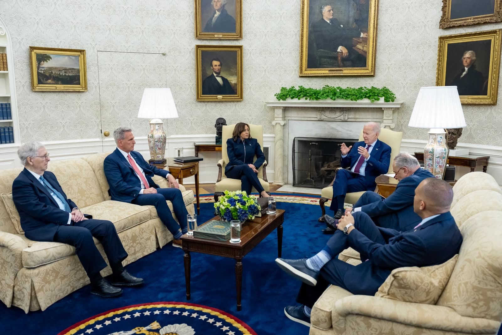 President Joe Biden, Vice President Kamala Harris, and congressional leaders in a meeting room.