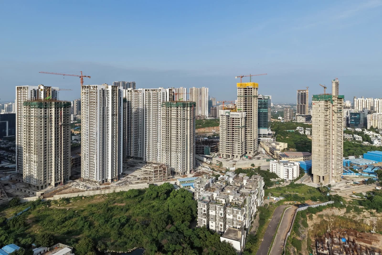 Aerial view of numerous high-rise buildings under construction in a city financial district.