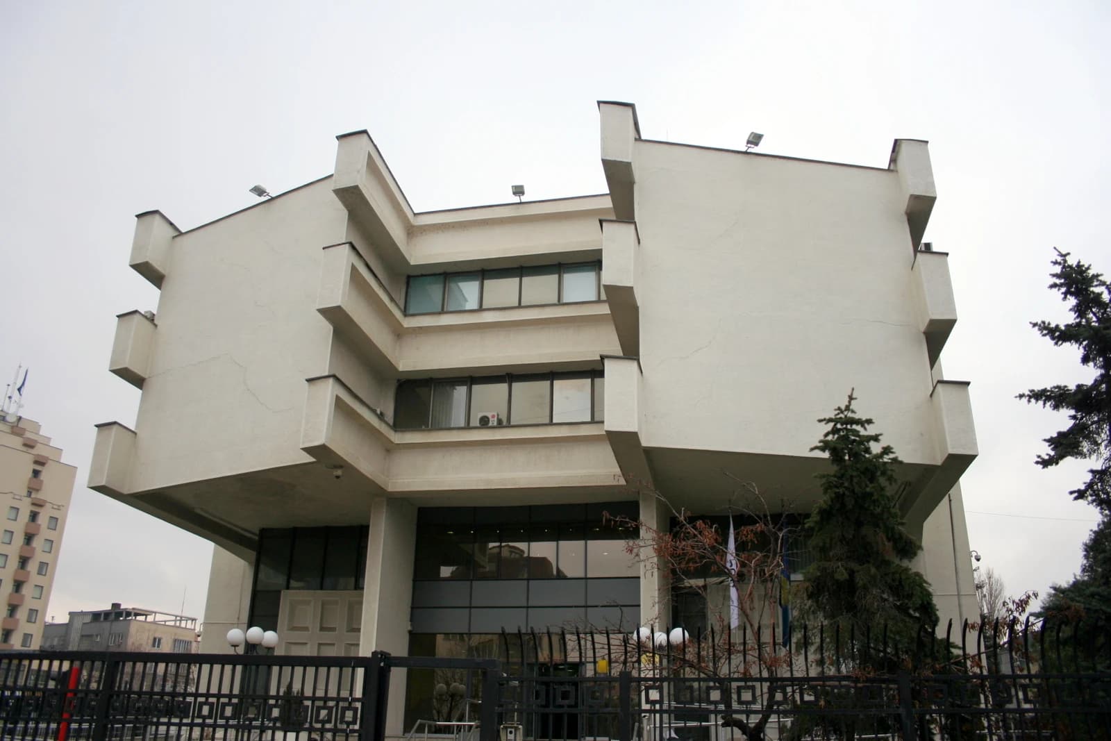Exterior shot of the Central Bank of Kosovo building under a grey sky.