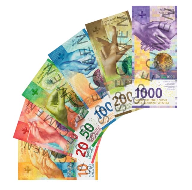 Swiss franc banknotes of various denominations fanned out on a white background.