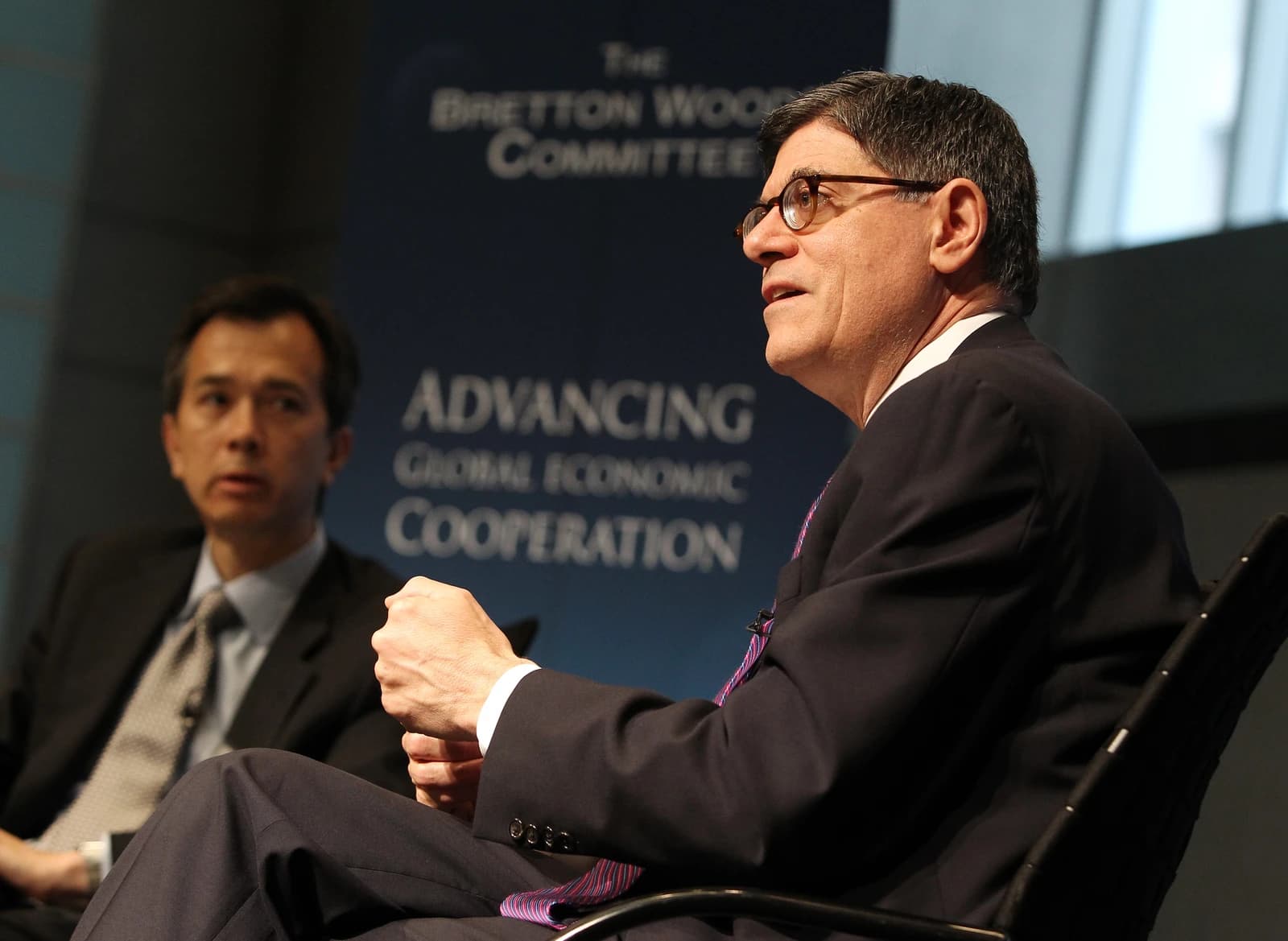 Secretary Jack Lew, wearing glasses and a suit, speaks at an event.