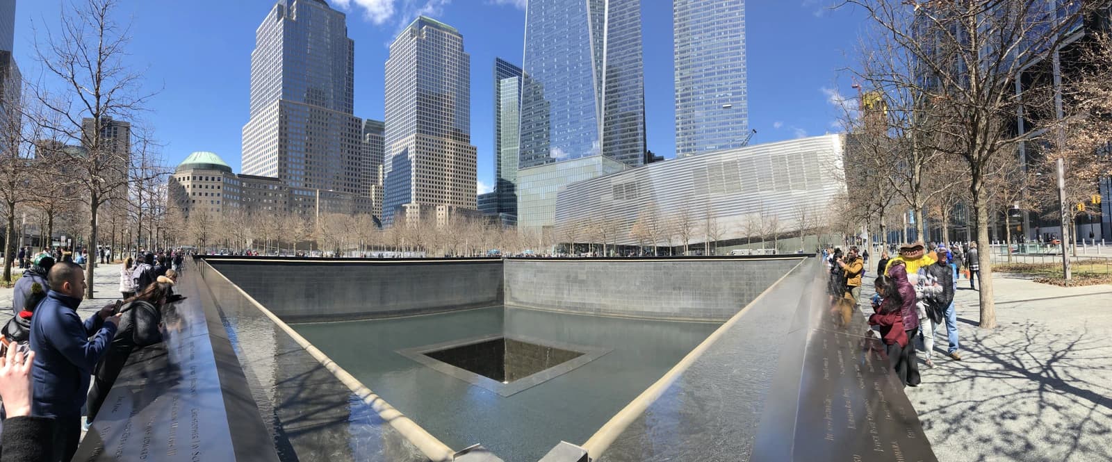 People viewing the cascading pools of the National September 11 Memorial in New York City.