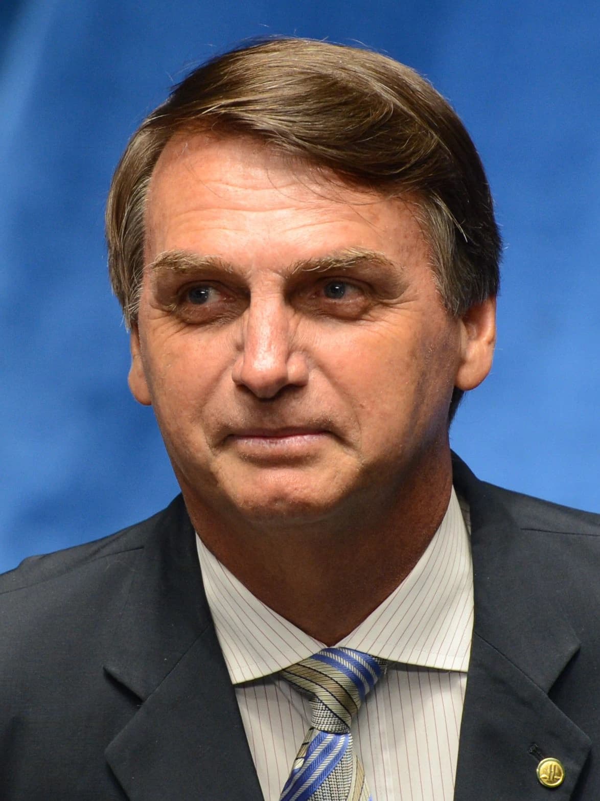 Jair Bolsonaro, former President of Brazil, looking towards the left side of the frame.
