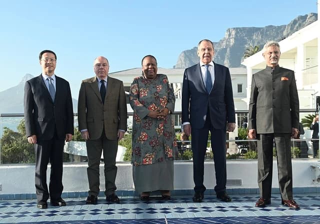 Five BRICS Foreign Ministers standing for a group photo outdoors.
