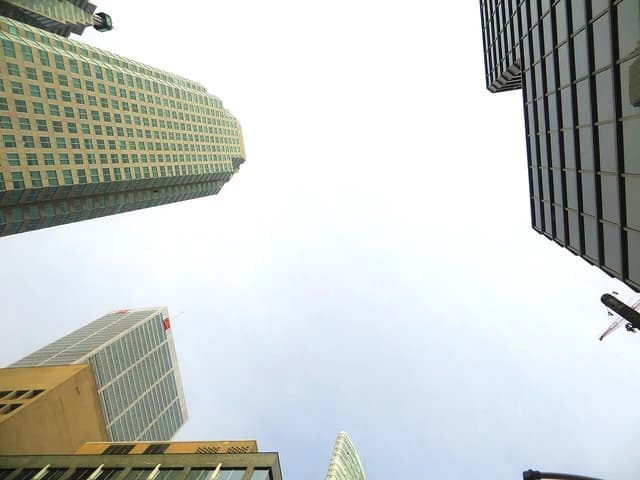 Brookfield Place towers in Toronto viewed from below on a cloudy day.
