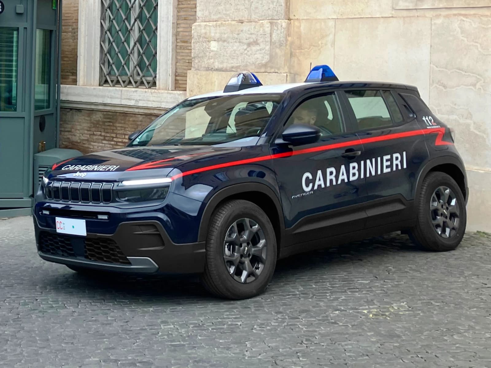 Italian Carabinieri electric Jeep Avenger patrol vehicle parked on a Roman street.