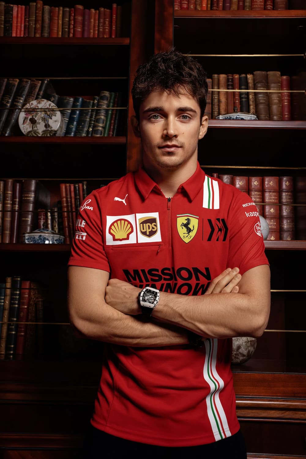 Charles Leclerc, Ferrari Formula 1 driver, standing with arms crossed.