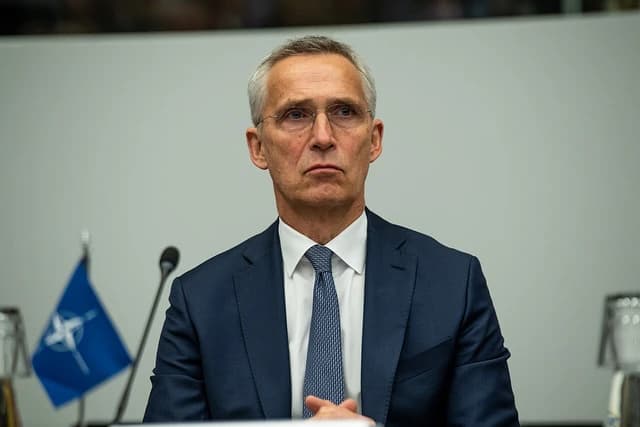 Jens Stoltenberg, NATO Secretary General, seated at a table during a meeting.