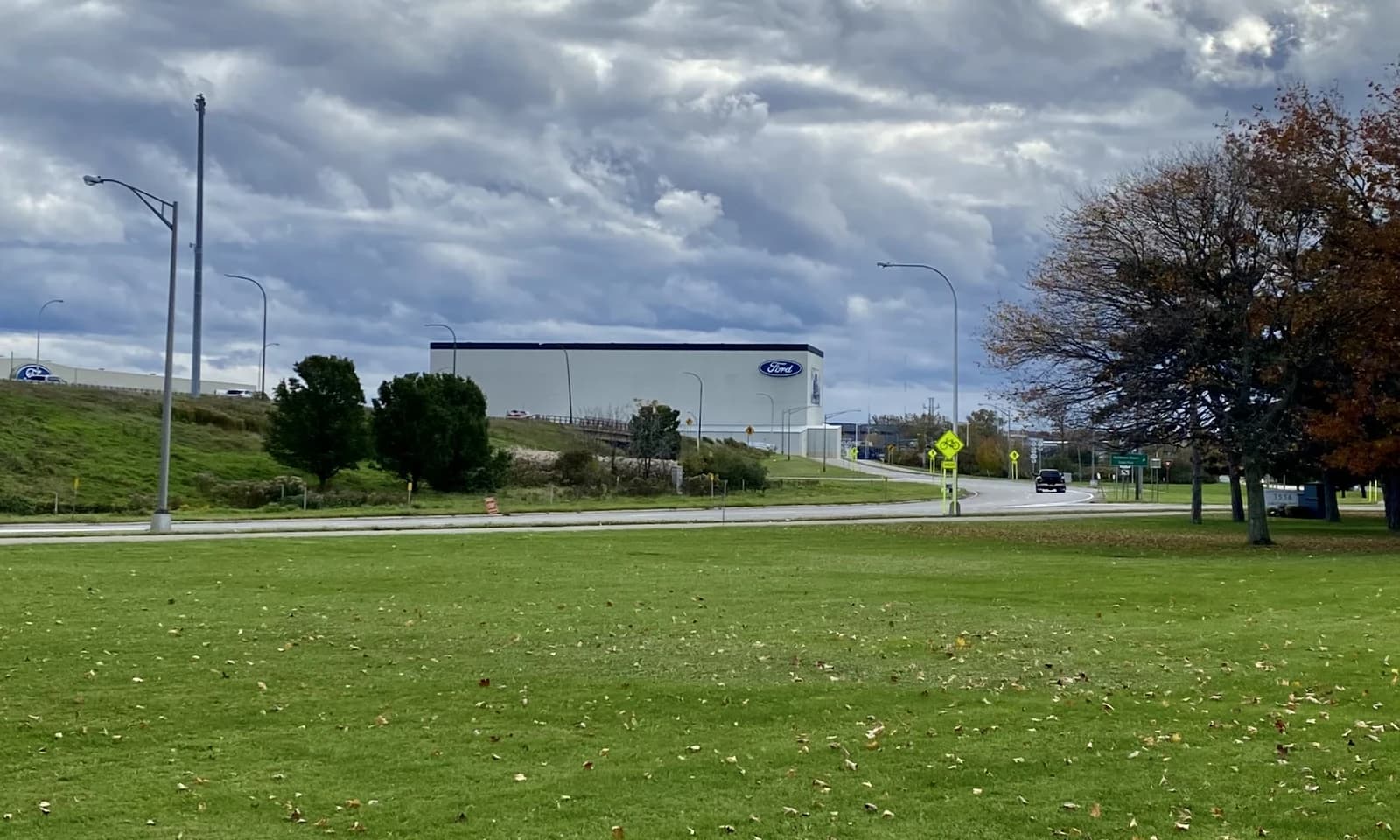 Exterior long shot of the Ford Buffalo Stamping Plant building under a cloudy sky.