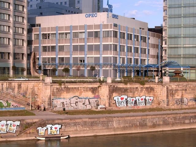 OPEC building in Vienna, Austria, located next to a river with a stone embankment.