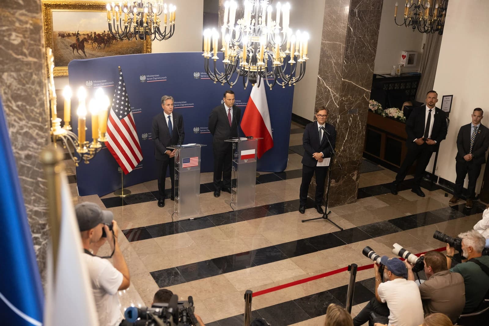 Secretary Blinken and Polish Foreign Minister standing at podiums during a joint press availability.