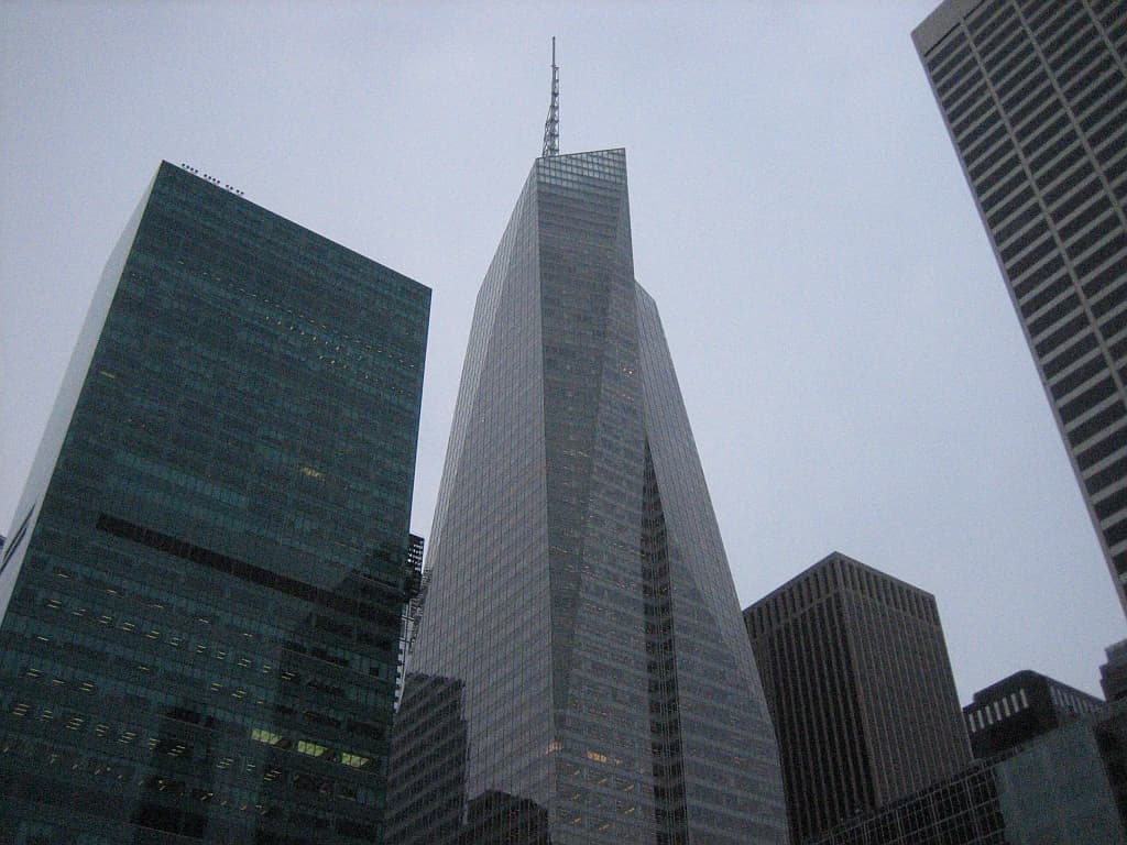 The Bank of America Tower, a skyscraper in New York City, against a gray sky.