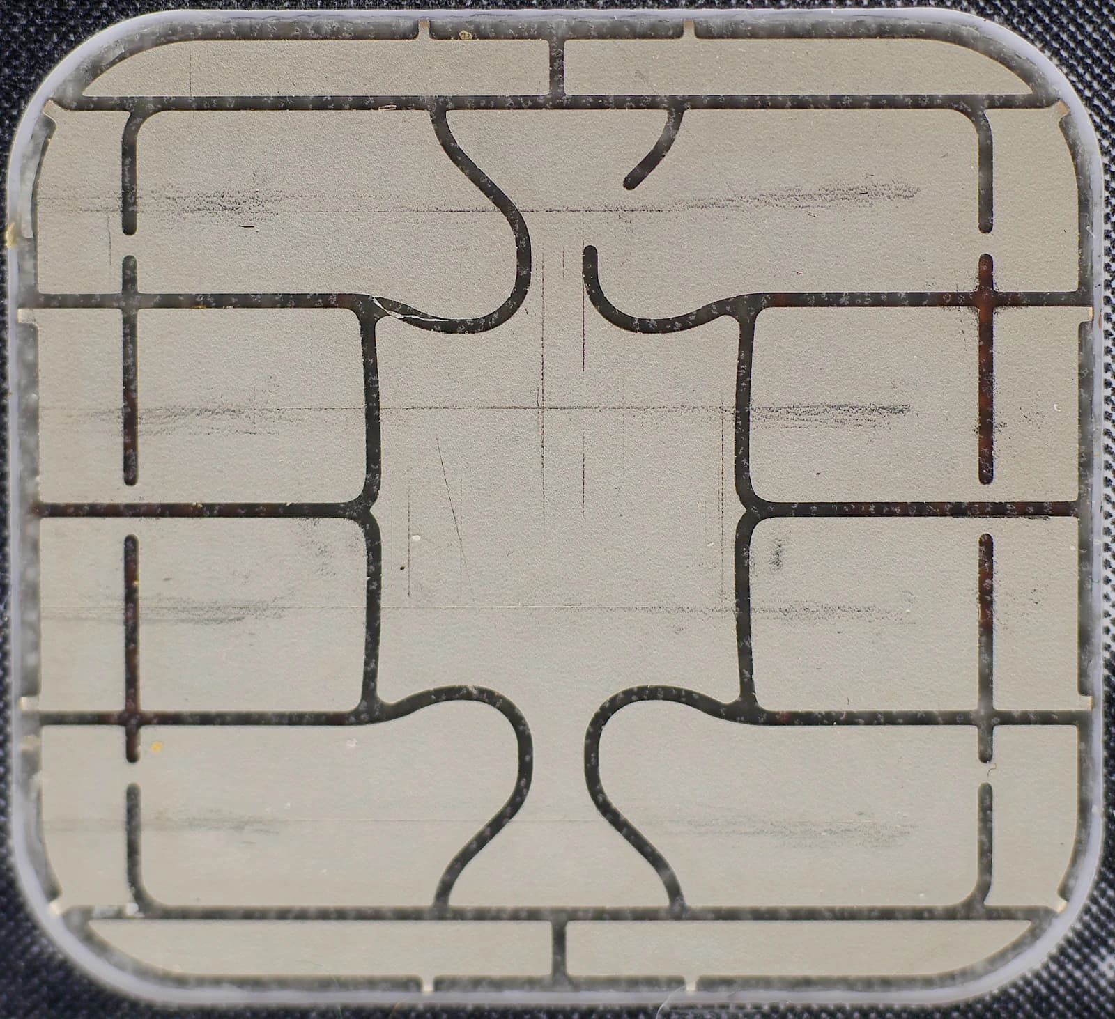 Close-up detail of a credit card's EMV chip, showing its contact points.