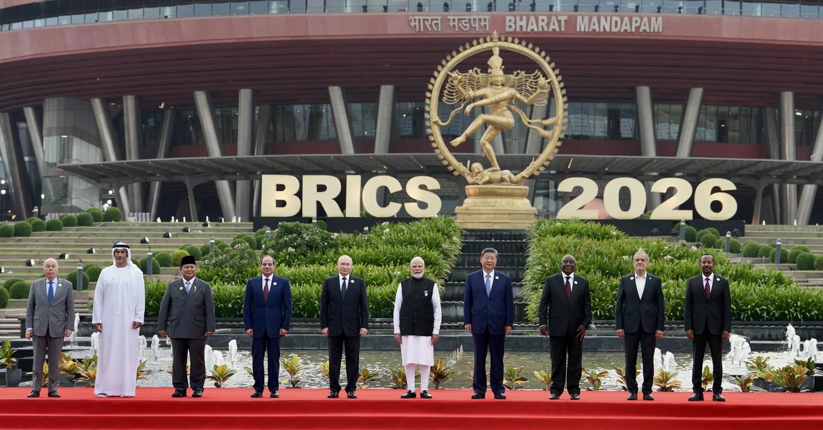 Leaders from BRICS nations and invited guests stand for a group photo outdoors.
