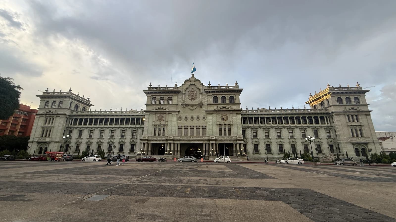 Palacio Nacional de la Cultura, a large historic building, under a cloudy sky.
