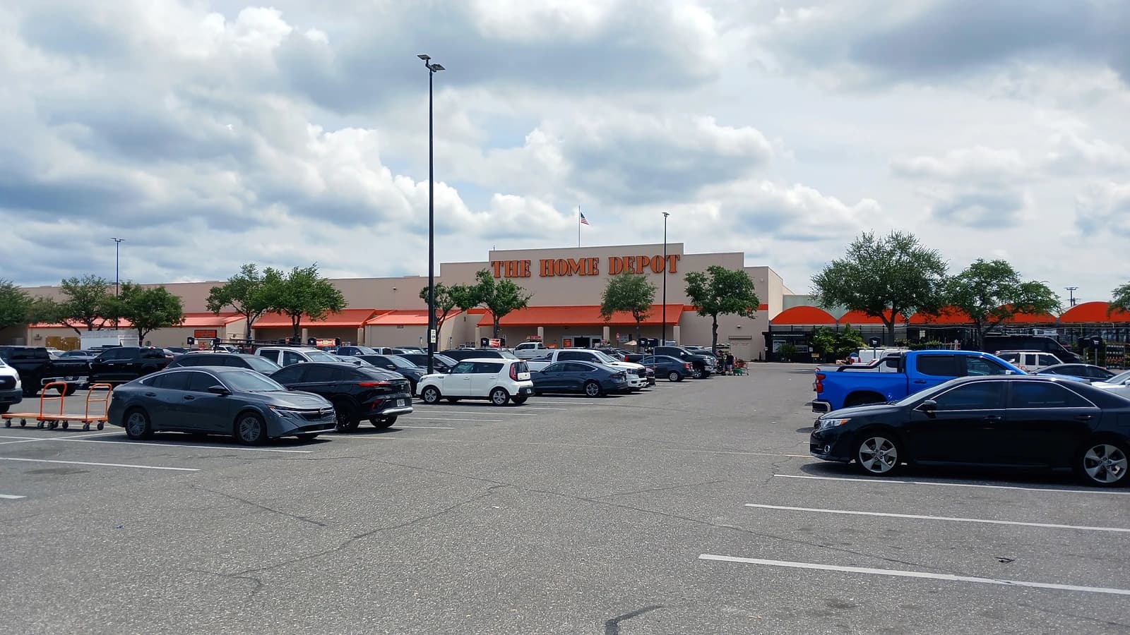 Home Depot store exterior and parking lot on a cloudy day in Tampa, Florida.