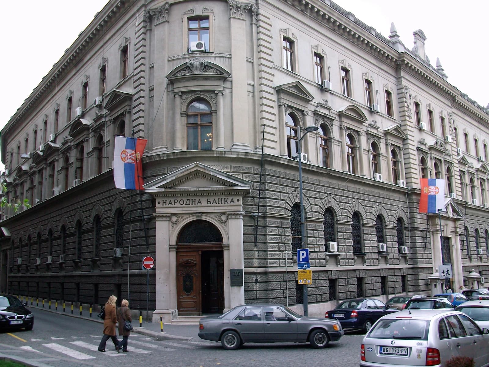 Exterior view of the National Bank of Serbia building with a Serbian flag.