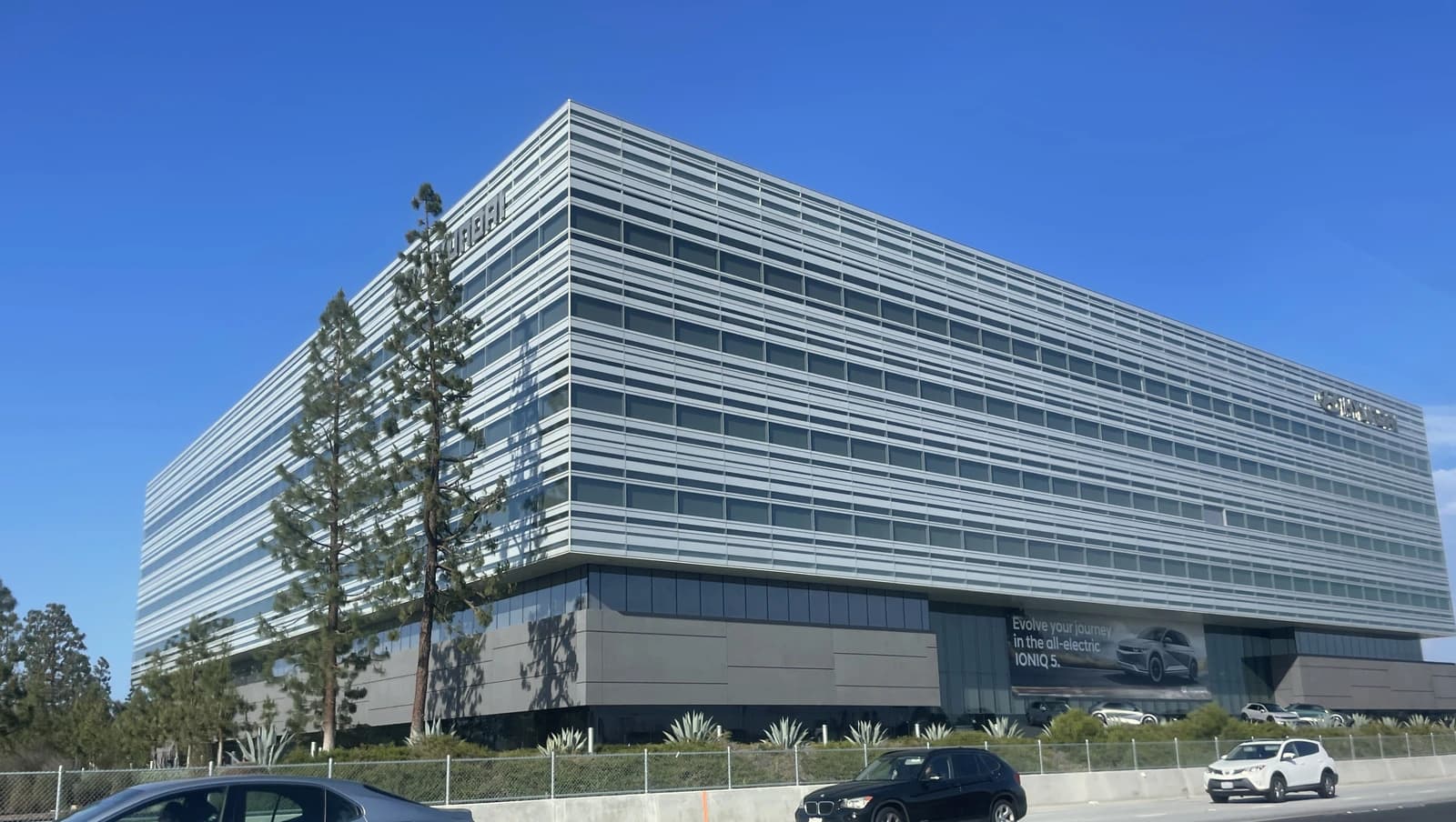 Hyundai Motor America Headquarters building in Fountain Valley, California, under a clear blue sky.