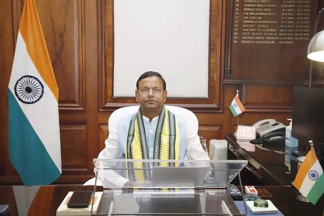 Shri Pankaj Chaudhary, Minister of State for Finance, seated at a desk in his office.