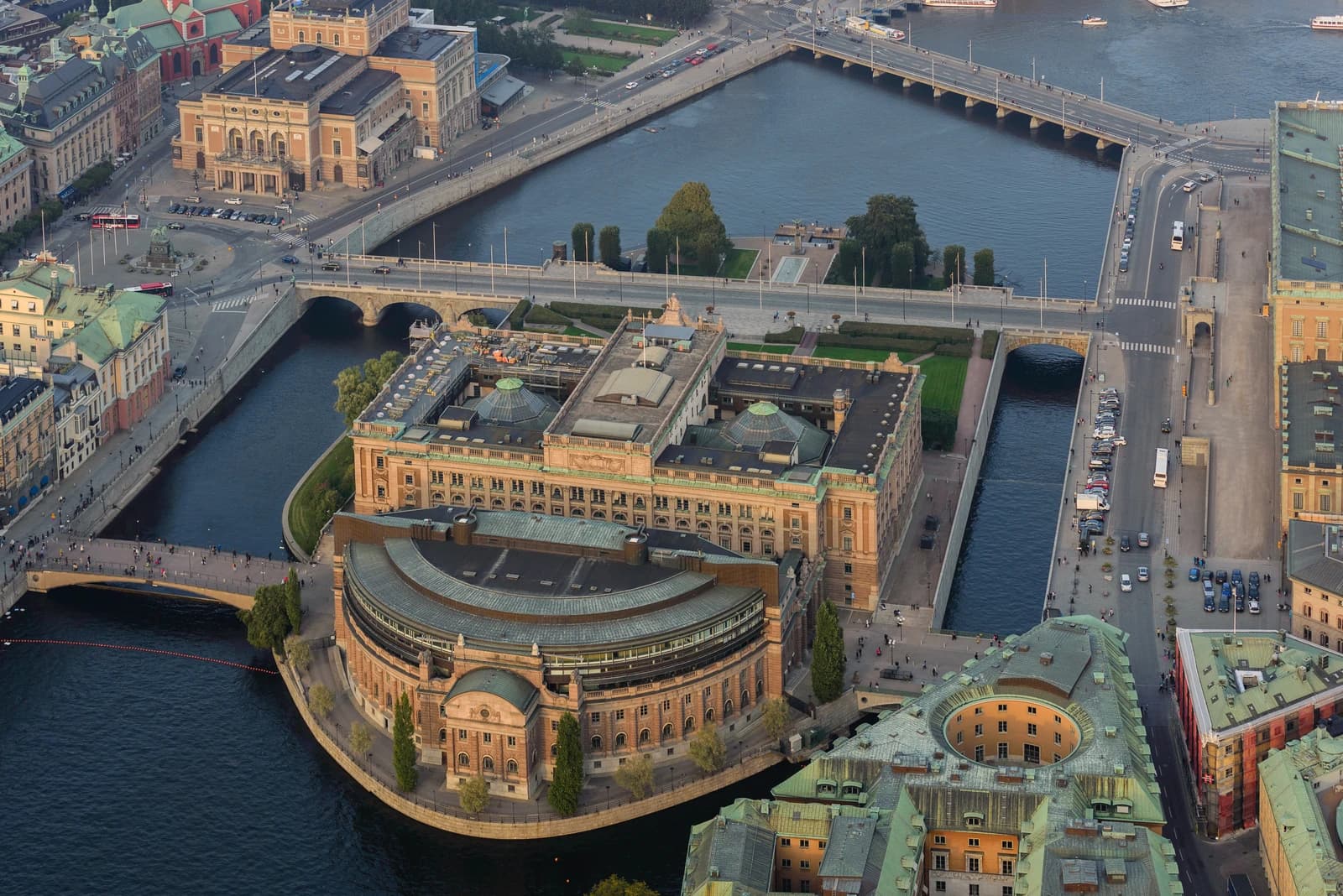 Aerial view of the Riksdagen building in Stockholm, Sweden, surrounded by canals and bridges.