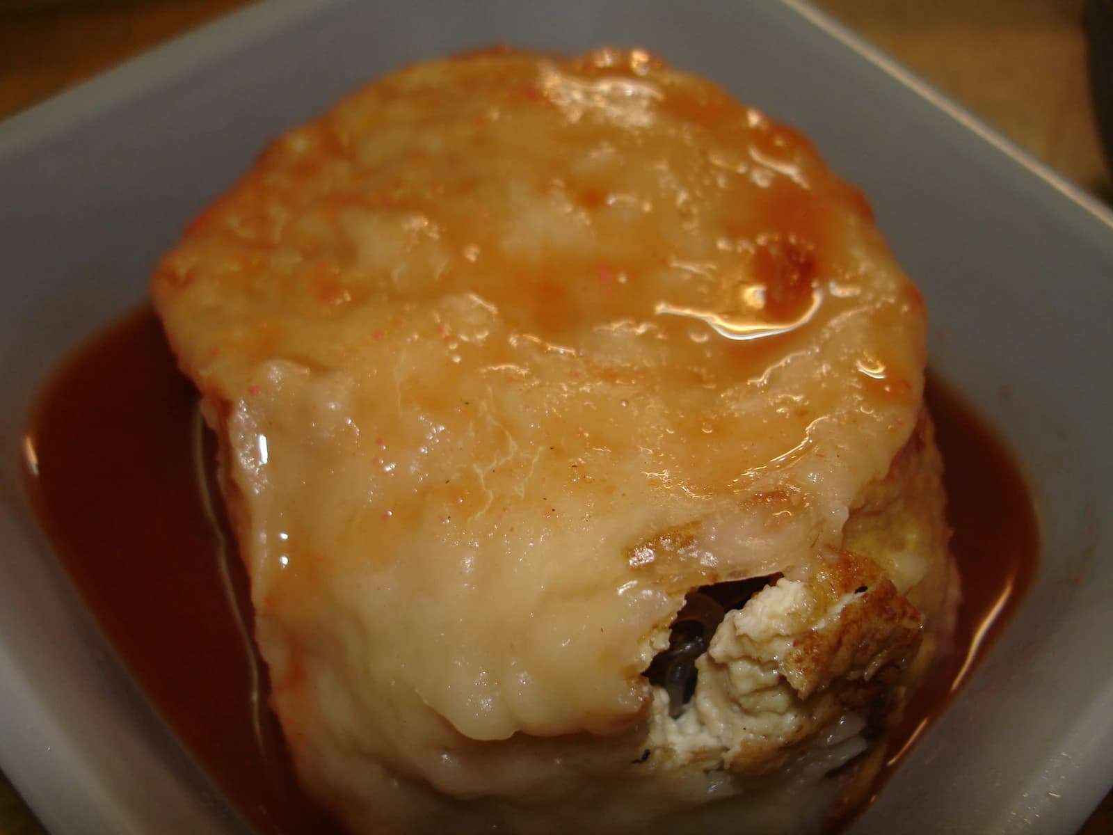Close-up view of a dish with a thick sauce and a visible filling.