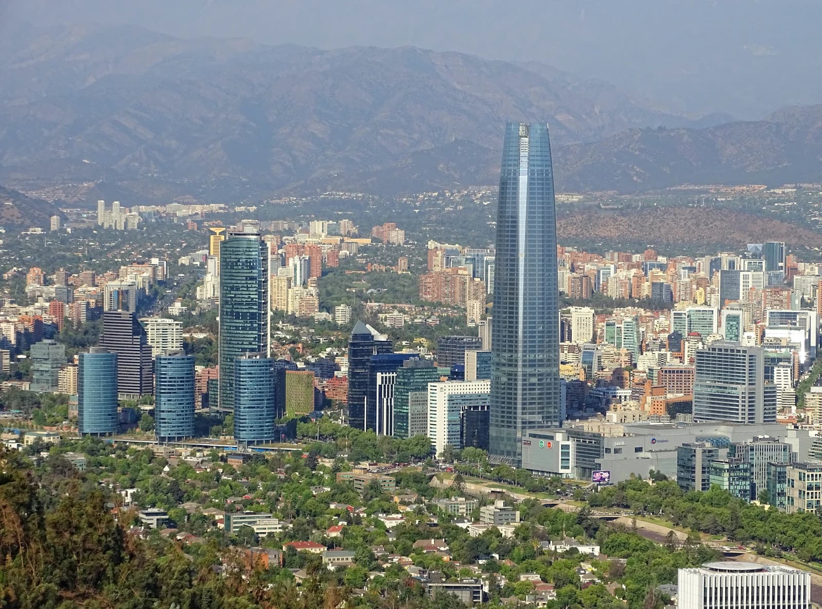 An aerial view of the Costanera Center skyscrapers towering above the city of Santiago, Chile.