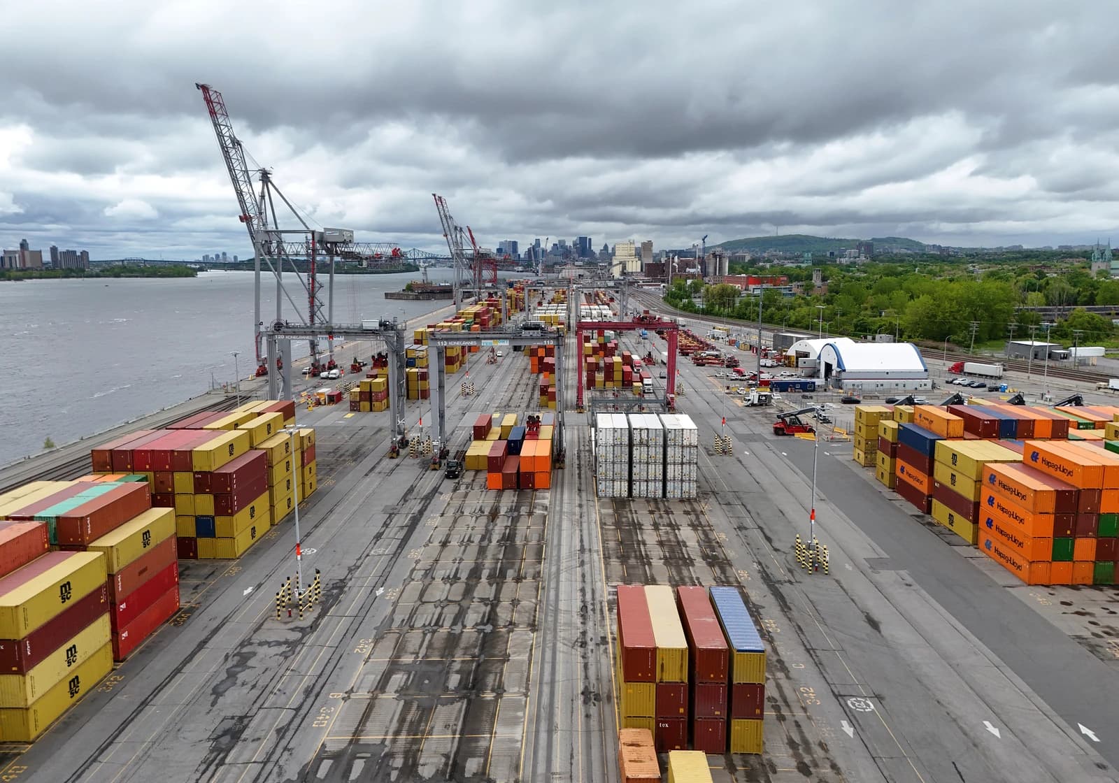 Shipping containers stacked high at the Port of Montreal terminal.