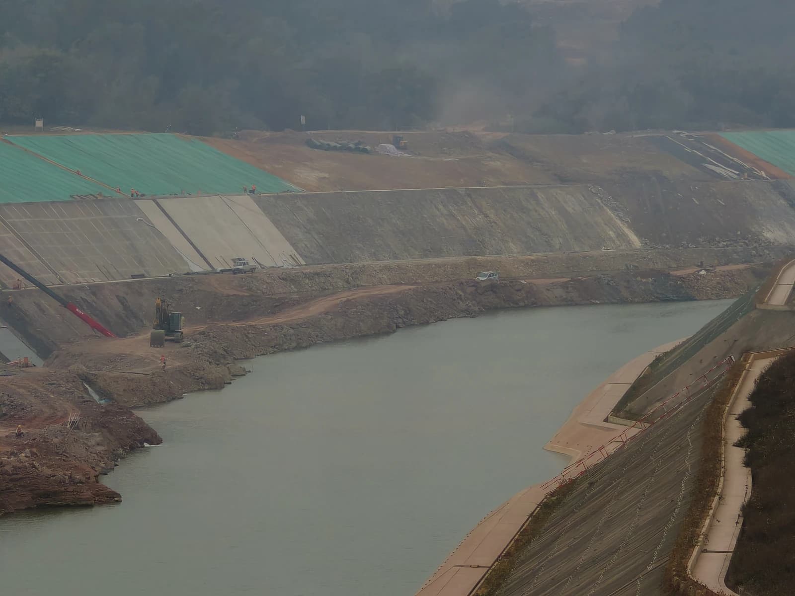 An aerial view of the Pinglu Canal construction site with water and embankments.