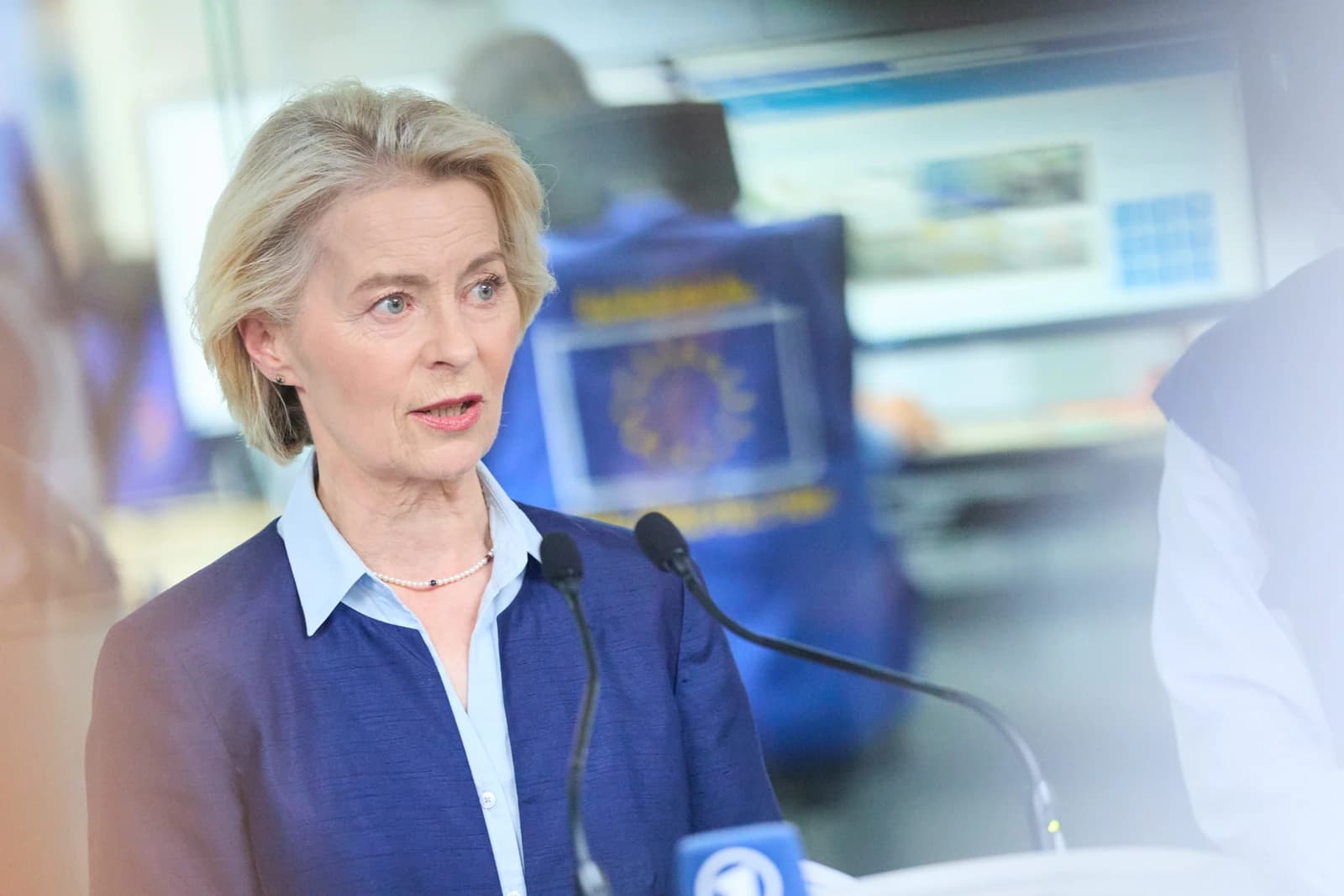 Ursula von der Leyen, President of the European Commission, speaking into microphones.
