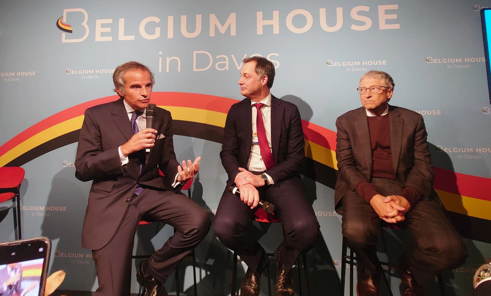 Rafael Mariano Grossi speaking into a microphone with Bill Gates seated next to him.
