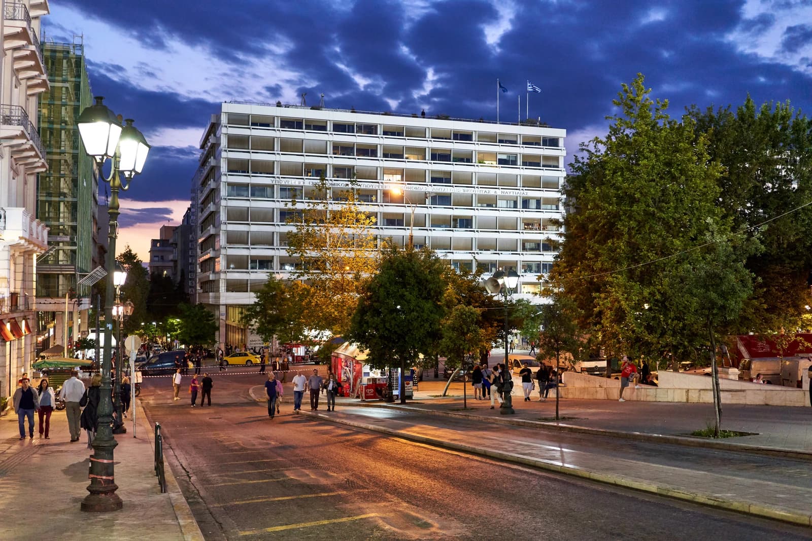 Hellenic Ministry of Finance building on a city street at dusk in Athens, Greece.