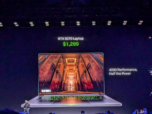 Jensen Huang, Nvidia CEO, stands next to a large display showing an RTX 5070 laptop.