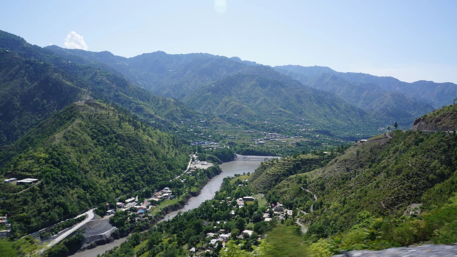 Aerial view of Patrind Hydropower Project with a river flowing through mountainous landscape.